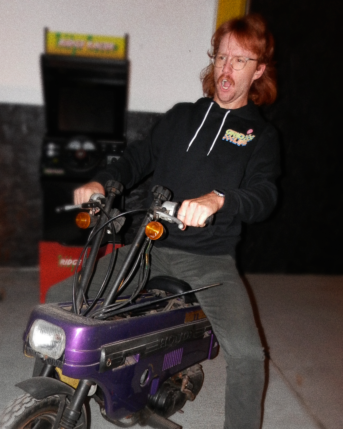Moped rider popping a sick wheelie while wearing the GRIDLIFE Season 23 hoodie.