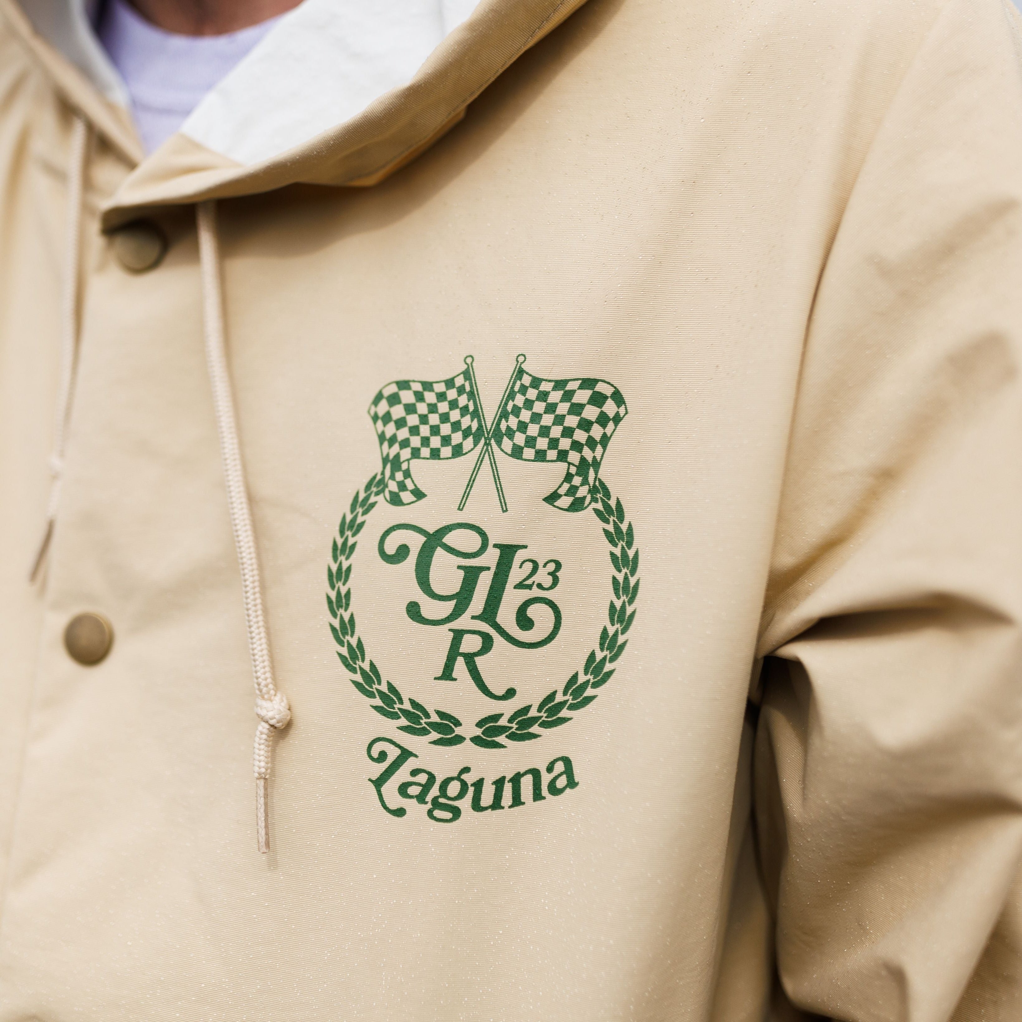 Close up of the crest on the GRIDLIFE hooded rain jacket