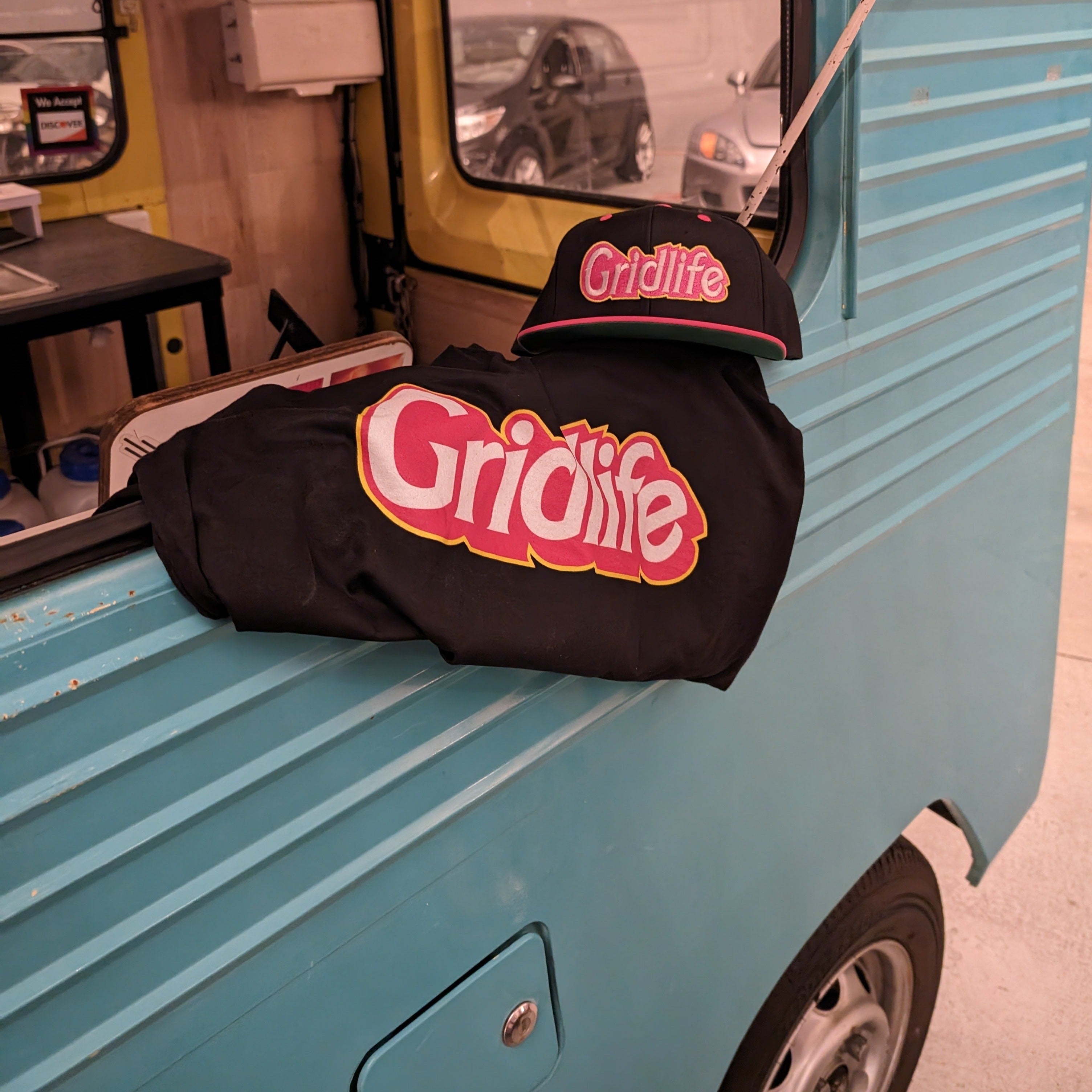 GRIDLIFE pink doll logo hat and t-shirt in the window of kei van