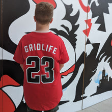 Super cool kid wearing the GRIDLIFE 23 legends jersey, showing the backside of it 