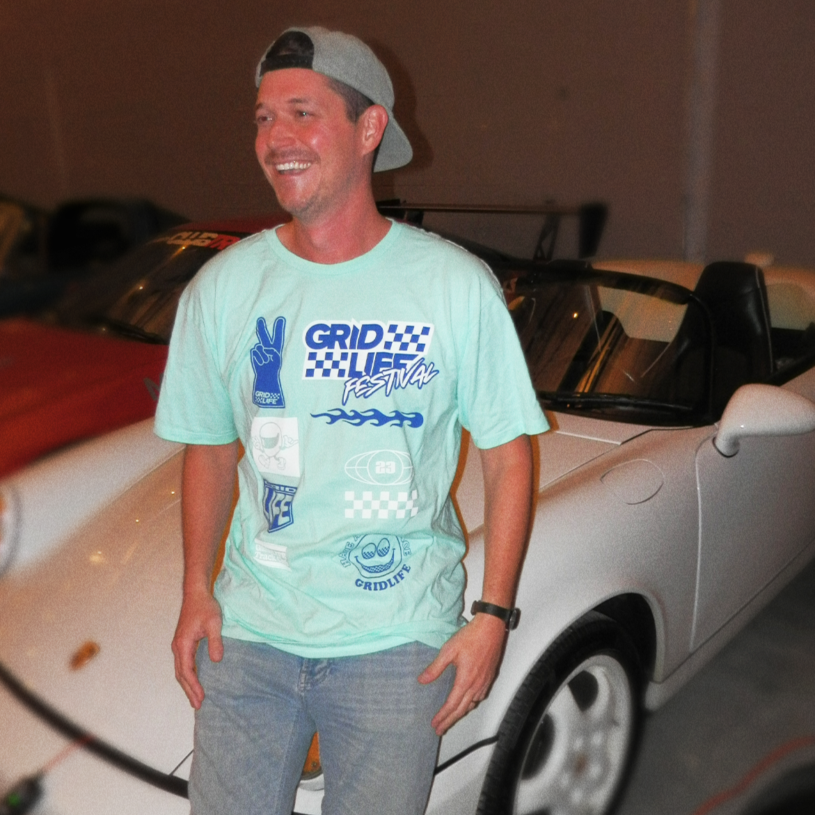 Model of GRIDLIFE 23 Midwest line up tee smiling 