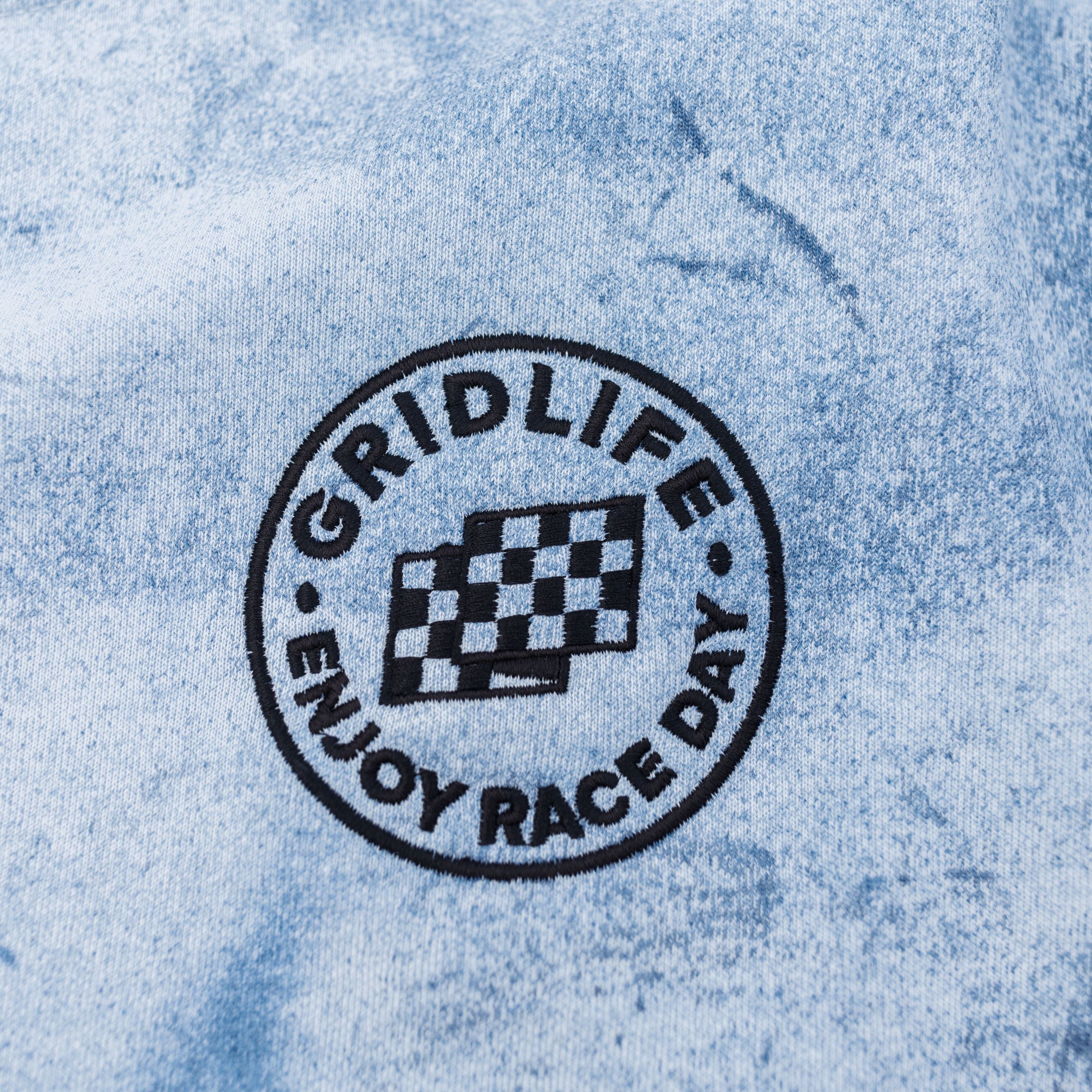 Close up of the Embroidered logo on the GRIDLIFE Enjoy Race Day crewneck 